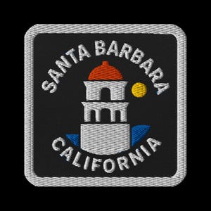 May include: Embroidered patch with the text "SANTA BARBARA CALIFORNIA" in white. The design includes a building with a red dome, a yellow circle, and blue details, set against a black backdrop.