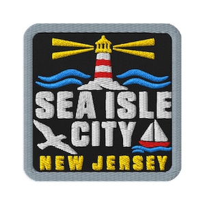 Peut inclure: Un écusson brodé carré à fond noir et bordure grise. Il représente un phare rouge et blanc avec des faisceaux lumineux jaunes, des vagues bleues, une mouette blanche, un voilier et le texte SEA ISLE CITY NEW JERSEY en blanc et jaune.