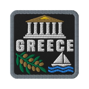 May include: A square embroidered patch with a black background and a gray border. It features a white Greek temple with a gold roof, the word GREECE in white capital letters, a green olive branch with brown olives, and a white sailboat on blue waves.