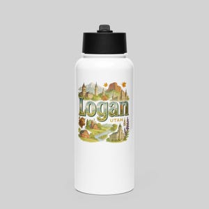 May include: A white water bottle with a black lid featuring the word "Logan" in a green and gold design. The design includes illustrations of buildings, mountains, and the state of Utah.