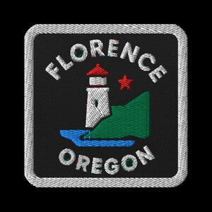 May include: Embroidered patch featuring a lighthouse with a red roof, a red star, and a green hill. The words "FLORENCE" and "OREGON" are arched above and below the central design, respectively. The patch has a black background and a gray border.