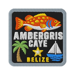 May include: A square embroidered patch with a gray border on a black background. It features an orange fish, a green palm tree, a yellow star, and a white sailboat. The text reads AMBERGRIS CAYE BELIZE in white and yellow embroidered lettering.