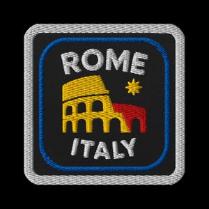 May include: Embroidered patch featuring the Colosseum in Rome, Italy. The design includes the words "ROME" and "ITALY" in white, with a yellow and red Colosseum illustration and a yellow star on a black background.
