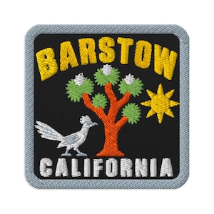 May include: A square embroidered patch with a black background and a light gray border. It features the yellow text BARSTOW at the top and CALIFORNIA at the bottom. A central orange tree with green foliage, a white bird, and a yellow sun are depicted.