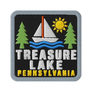 May include: A square embroidered patch with a black background featuring a white sailboat with an orange mast, a yellow sun, and two green pine trees. Below, the text reads TREASURE LAKE in white and PENNSYLVANIA in yellow, all bordered in gray.