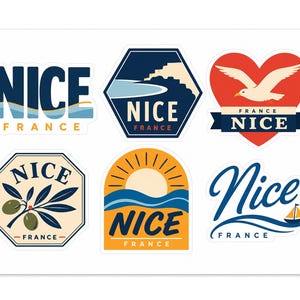 May include: A sticker sheet featuring six distinct designs related to Nice, France. The graphics include text reading NICE FRANCE, a coastal landscape, a heart with a seagull, an olive branch, a sunset over waves, and a sailboat with cursive text.