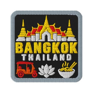 May include: A square embroidered patch with a black background and a light gray border. It features a yellow and white Thai temple, the text BANGKOK THAILAND in yellow and white, a red tuk-tuk, a white lotus flower, and a bowl of noodles.