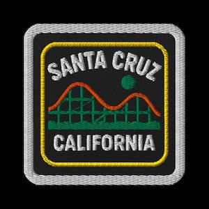 May include: Embroidered patch featuring the words "SANTA CRUZ CALIFORNIA" in white, with a roller coaster design in orange and green. The patch has a black background, a yellow border, and a gray stitched edge.
