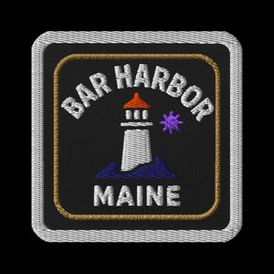 May include: Embroidered patch featuring a lighthouse with the text "BAR HARBOR MAINE". The lighthouse is white with a red top, set against a black background. The patch has a gold border and a white stitched edge.