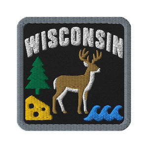 May include: A square embroidered patch with a black background and a gray border. The text WISCONSIN is stitched in white at the top. Below, there is a green pine tree, a brown deer, a yellow wedge of cheese, and blue water waves.