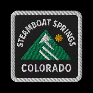 May include: Embroidered patch featuring the words "Steamboat Springs Colorado" in white, arched above and below a green mountain design with a yellow sun. The patch has a black background and a white border.