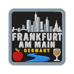 May include: A square embroidered patch with a grey border on a black background. It features a white skyline of Frankfurt, the text FRANKFURT AM MAIN in white, GERMANY in yellow, a red apple, a blue river, and a white wine glass icon.