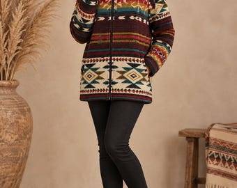 May include: A hooded zip-up jacket featuring a multi-colored geometric pattern in shades of burgundy, cream, teal, and orange, paired with black slim-fit trousers and black leather ankle boots.