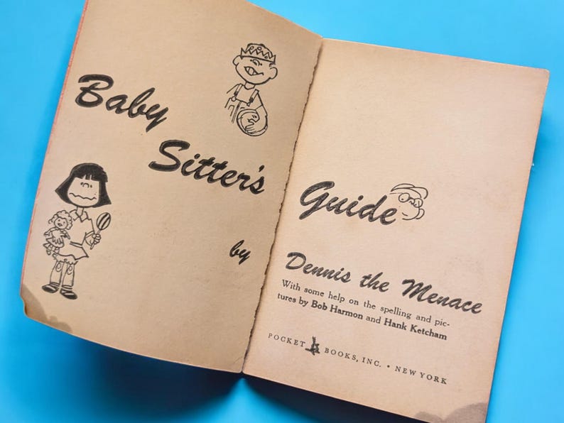 May include: A vintage paperback book titled "Baby Sitter's Guide by Dennis the Menace" with illustrations of children. The book cover is beige with black text and illustrations.