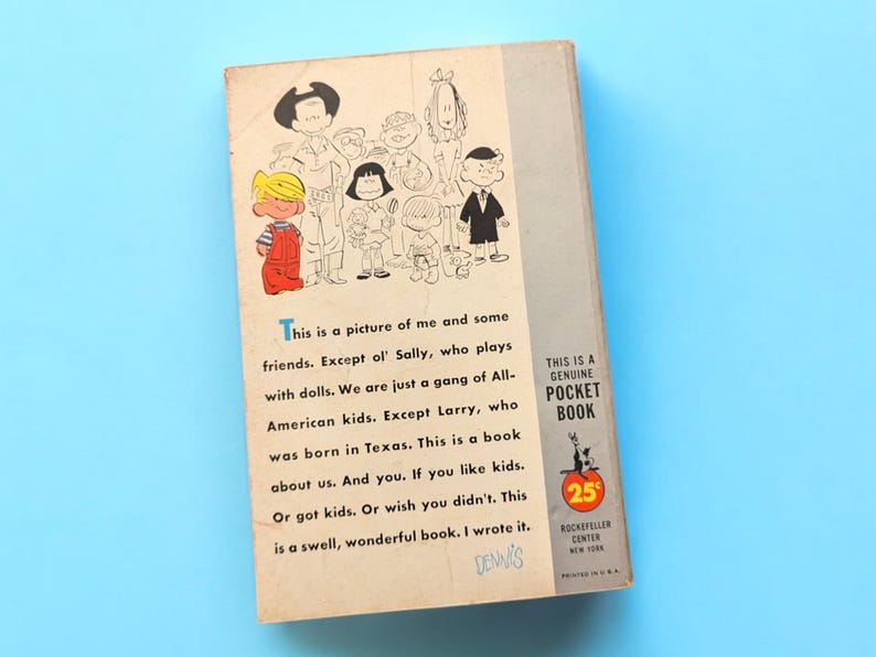 May include: A vintage paperback book cover featuring a cartoon illustration of a group of children, including Dennis the Menace. The text on the cover reads "This is a picture of me and some friends. Except ol' Sally, who plays with dolls. We are just a gang of All-American kids. Except Larry, who was born in Texas. This is a book about us. And you. If you like kids. Or got kids. Or wish you didn't. This is a swell, wonderful book. I wrote it. DENNIS." The back cover features a "This is a Genuine Pocket Book" logo with a price of 25 cents.