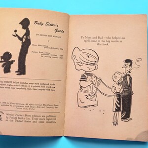May include: A vintage book titled "Baby Sitter's Guide" by Dennis the Menace. The book has a black and white illustration of a child holding a leash with two other children. The book cover includes publication dates and information about the Pocket Book edition.