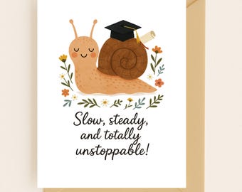 May include: A graduation card featuring a cartoon snail wearing a graduation cap and holding a diploma. The snail is surrounded by flowers and leaves. The text on the card reads "Slow, steady, and totally unstoppable!"