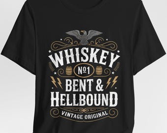 May include: Black t-shirt featuring a vintage-style graphic with the text "Whiskey No. 1 Bent & Hellbound Vintage Original." The design includes an eagle, barrels, and lightning bolts.