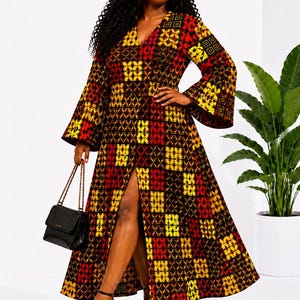 May include: A long, patterned dress with a V-neck and flared sleeves. The dress features a patchwork design in red, yellow, and brown. A black handbag and black high heels complete the look. The dress has a high slit.