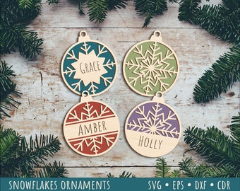 May include: Four wooden Christmas baubles with snowflake designs. Each bauble has a different colour and a name written on it: Grace, Amber, Holly.  SVG, EPS, DXF, and CDR files are included.