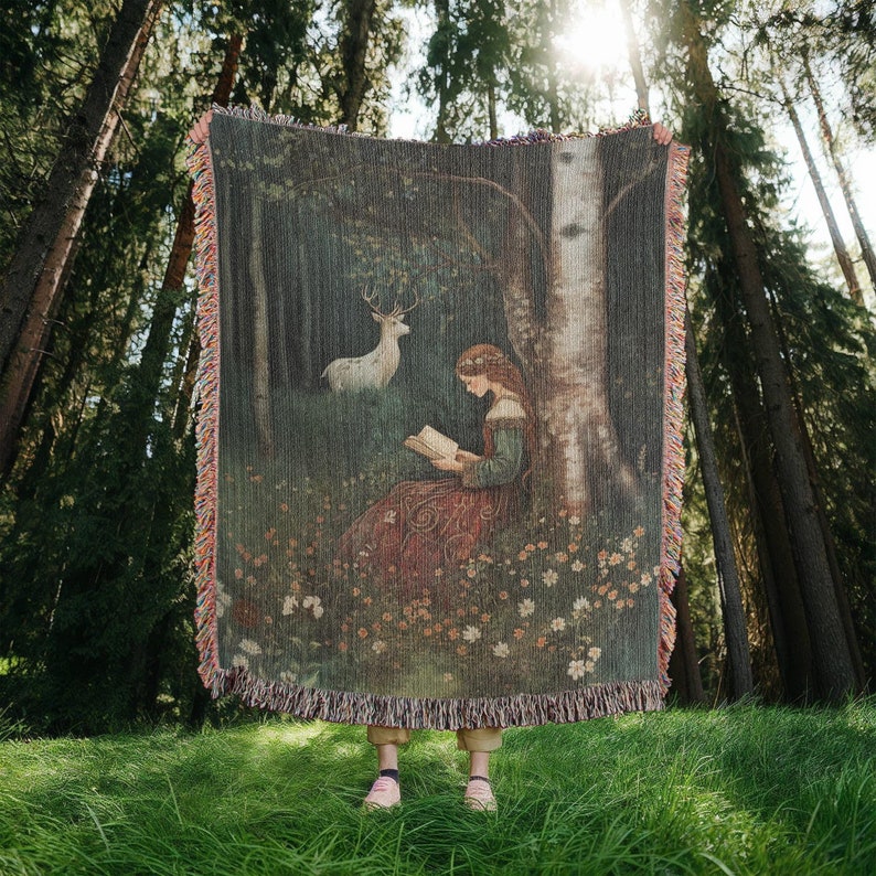 100 percent cotton woven wall hanging tapestry or blanket featuring a medieval maiden reading a book in a forest surrounded by flowers while a majestic white stag watches over her