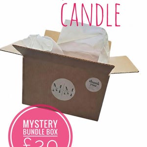 May include: A brown cardboard box with the text "waxmelts and CANDLE" in pink. The box is open, revealing white tissue paper and a white object. A pink circle with "MYSTERY BUNDLE BOX" and a price is at the bottom.