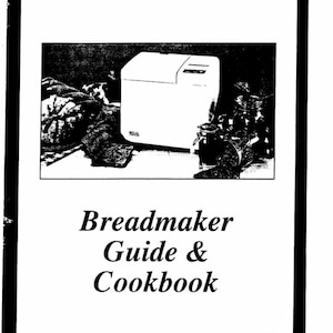 May include: A white breadmaker with the word "REGAL" printed on the front. The breadmaker is sitting on a table with a brown tablecloth. The text "Breadmaker Guide & Cookbook" is printed below the image. The text "Model No. K6751" is printed at the bottom of the page.