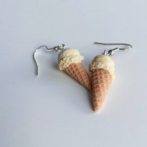 Vanilla ice cream dangle earrings on a white background.