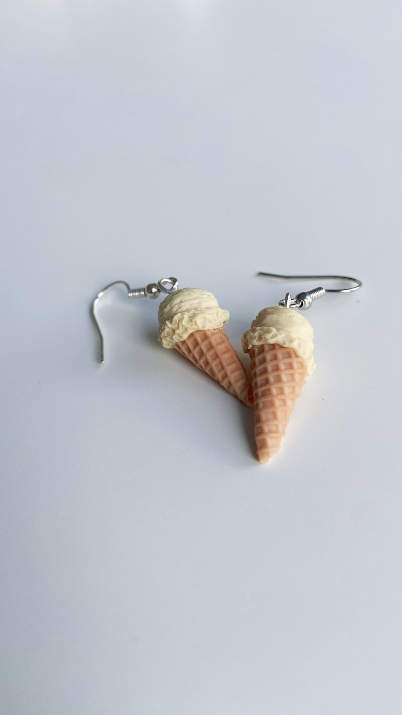 Vanilla ice cream dangle earrings on a white background.