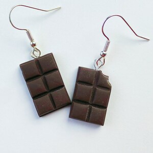 Dark chocolate bar dangle earrings. Right chocolate bar is missing a tiny bite of the chocolate in the top corner.