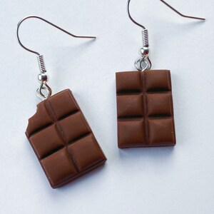 Milk chocolate bar dangle earrings. Left chocolate bar is missing a tiny bite of the chocolate in the top corner.