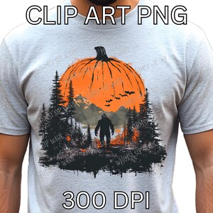 May include: A light gray t-shirt featuring a Halloween-themed graphic. The design includes a large orange pumpkin, a silhouette of a Bigfoot-like creature, trees, mountains, and bats. The text "CLIP ART PNG" and "300 DPI" are also visible.