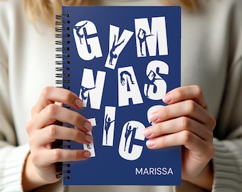 May include: A dark blue spiral-bound notebook featuring the word GYMNASTICS in large white letters, with silhouettes of gymnasts performing various poses integrated into the typography. The name MARISSA is printed in white at the bottom right.