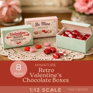 May include: Miniature retro Valentine's chocolate boxes. The image shows three small boxes, one open and filled with red foil-wrapped chocolates. Two boxes are closed, with text that reads "Be Mine Sweets" and "Valentine Sweets Handmade".