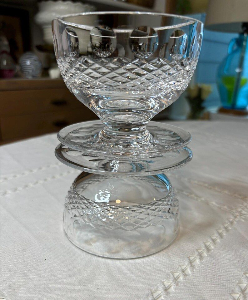 May include: A set of three clear glass bowls with a diamond pattern. The bowls are stacked on top of each other.