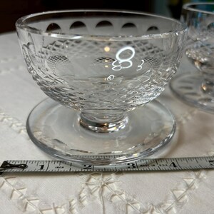 May include: Two clear glass dessert dishes with a pedestal base and a decorative diamond pattern. The dishes are 3 inches in diameter.
