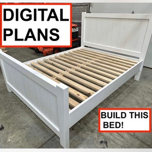 May include: White wooden bed frame with slatted headboard and footboard. The bed frame is assembled and ready for a mattress. The text "BUILD THIS BED!" is visible in the lower right corner of the image.