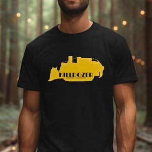 May include: Black t-shirt with a yellow graphic of a bulldozer and the text "KILLDOZER" with the words "GRAND JUNCTION, COLORADO" underneath.