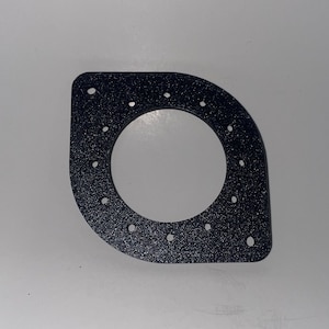 May include: Black plastic ring with a circular cutout and multiple small holes around the edge.
