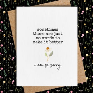 May include: A white card with black text that reads "sometimes there are just no words to make it better i am so sorry". A small watercolor illustration of a white daisy with a yellow center is above the text.