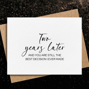 May include: A white card with black text that reads "Two years later and you are still the best decision I ever made".