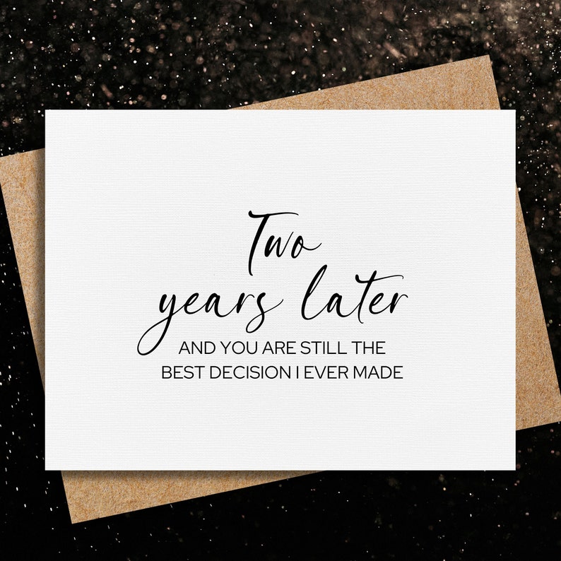 May include: A white card with black text that reads "Two years later and you are still the best decision I ever made".