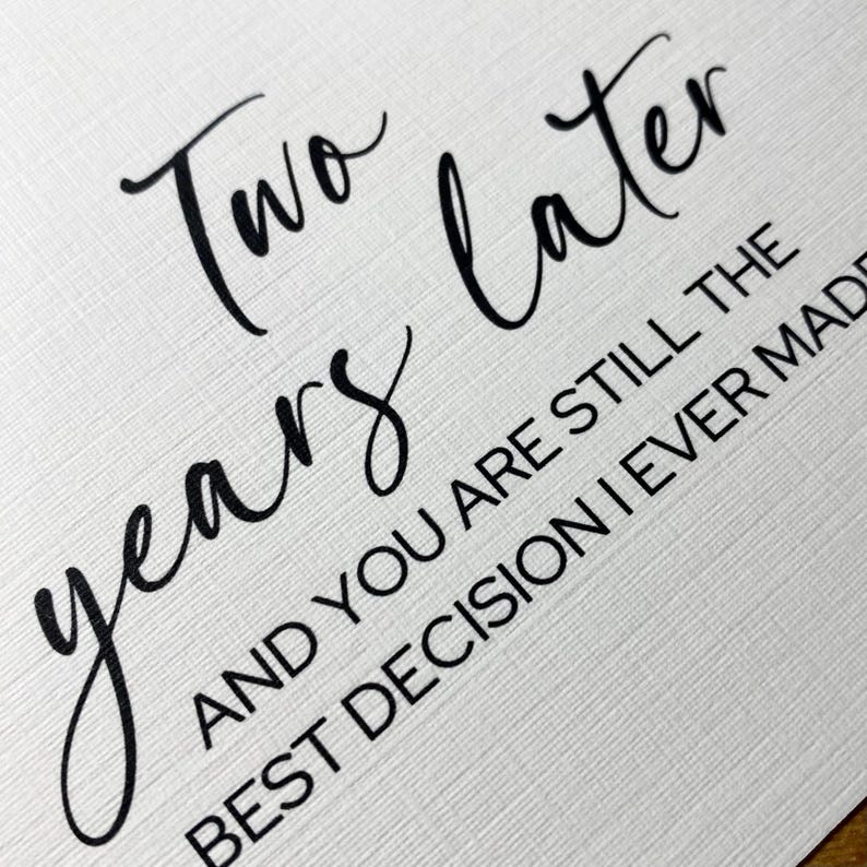 May include: A white card with black text that reads "Two years later and you are still the best decision I ever made."
