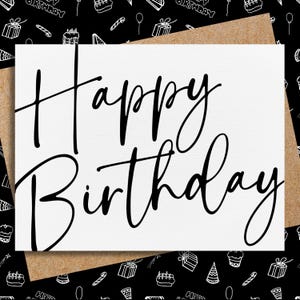 May include: A white greeting card with the words "Happy Birthday" in elegant black script. The card is set against a brown envelope, with a black and white birthday-themed pattern in the background.