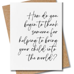 May include: A white greeting card with black cursive text that reads: How do you begin to thank someone for helping to bring your child into the world? The card is positioned on top of a brown kraft paper envelope with a visible textured surface.