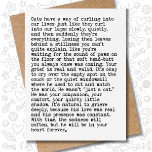 May include: A sympathy card with a heartfelt message about the loss of a cat. The text is printed in black on a white card, set against a brown envelope. The card's message is about grief and remembrance.