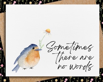 Può includere: Un'illustrazione ad acquerello di un passero blu che tiene un margherita nel becco. Lo sfondo è bianco con il testo "Sometimes there are no words" in corsivo nero.