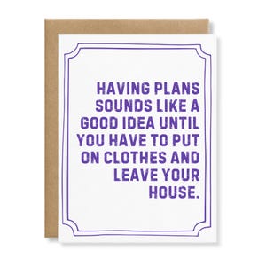 May include: A white greeting card with a purple decorative border and the purple text: HAVING PLANS SOUNDS LIKE A GOOD IDEA UNTIL YOU HAVE TO PUT ON CLOTHES AND LEAVE YOUR HOUSE. The card is paired with a brown envelope visible behind it.