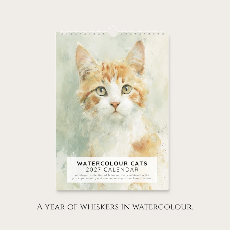 A calendar for the year 2027, featuring a close-up portrait of a cat with a watercolor painting background.