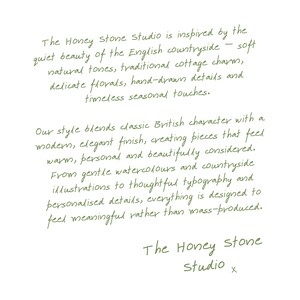 The image is a handwritten text that describes the Honey Stone Studio, which is inspired by the quiet beauty of the English countryside. The studio blends classic British character with a modern, elegant finish, creating pieces that feel warm, personal, and beautifully considered. The studio uses gentle watercolours and countryside illustrations to thoughtful typography and personalised details, everything is designed to feel meaningful rather than mass-produced.